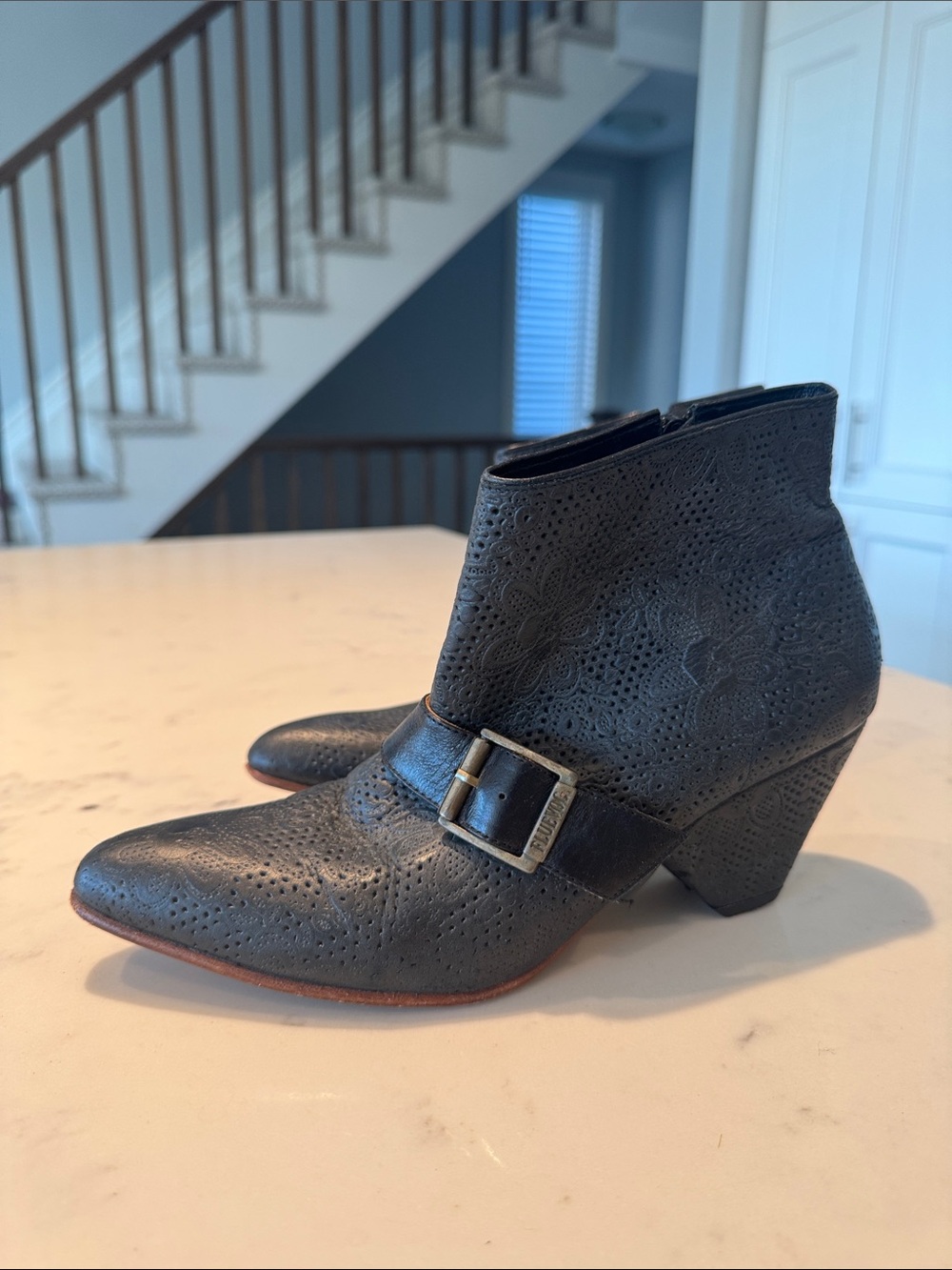 John Fluevog Black “Determination” perforated Floral Buckle Ankle Boots